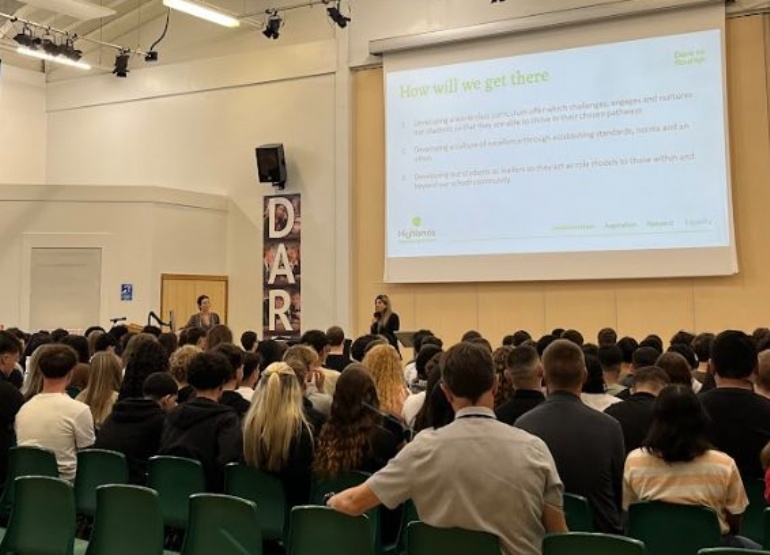 students watching a presentation in the main hall